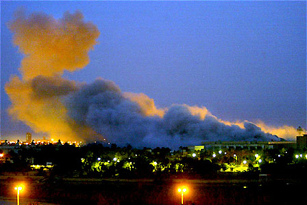 Smoke rose from a presidential compound in central Baghdad after heavy overnight bombing, early March 31, 2003.